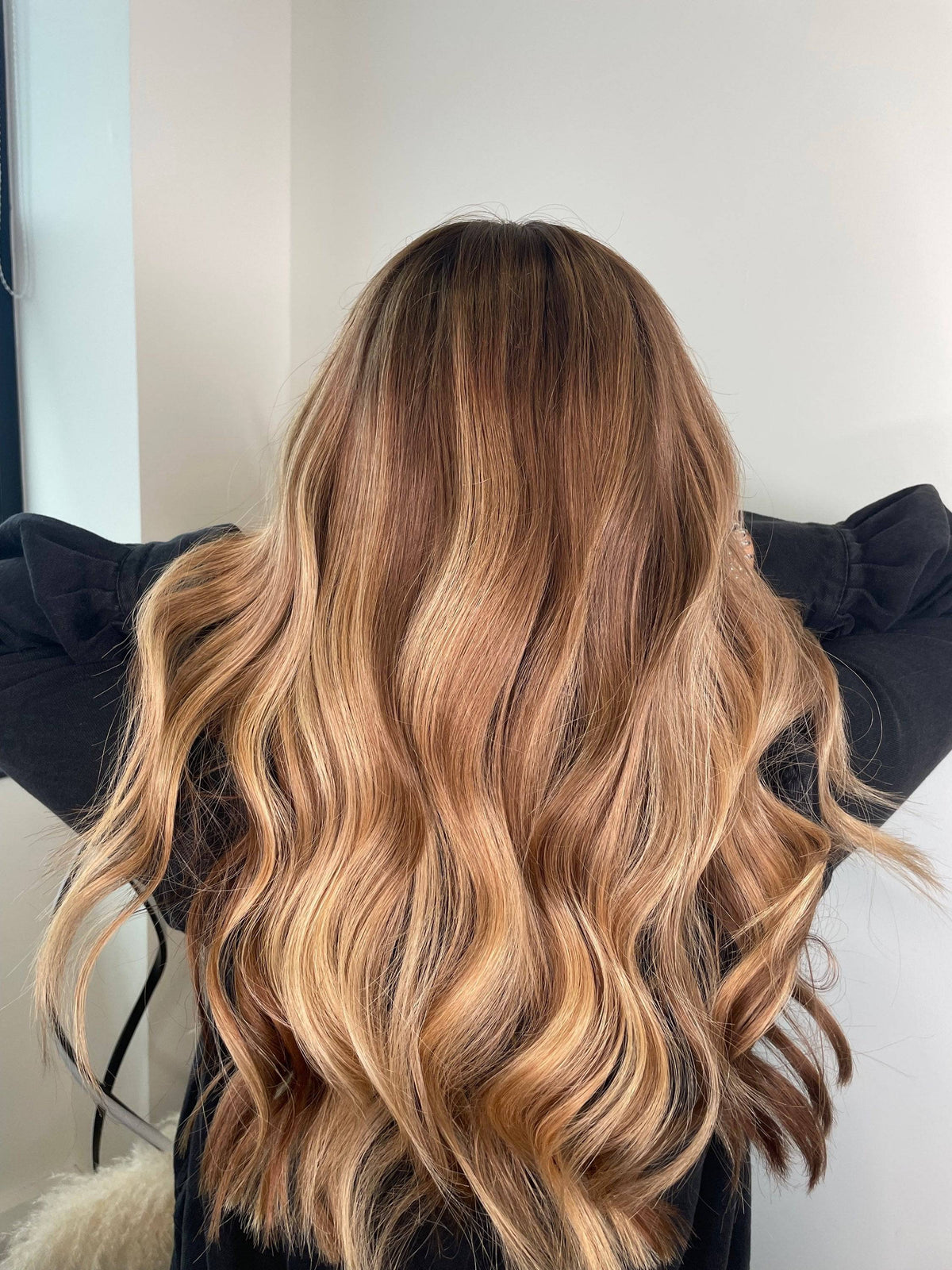 Model showcasing a brown balayage wig with a natural hairline and body wave texture.