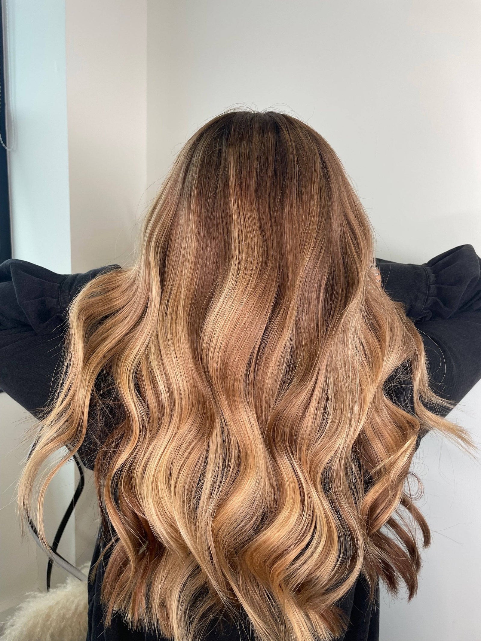 Model showcasing a brown balayage wig with a natural hairline and body wave texture.