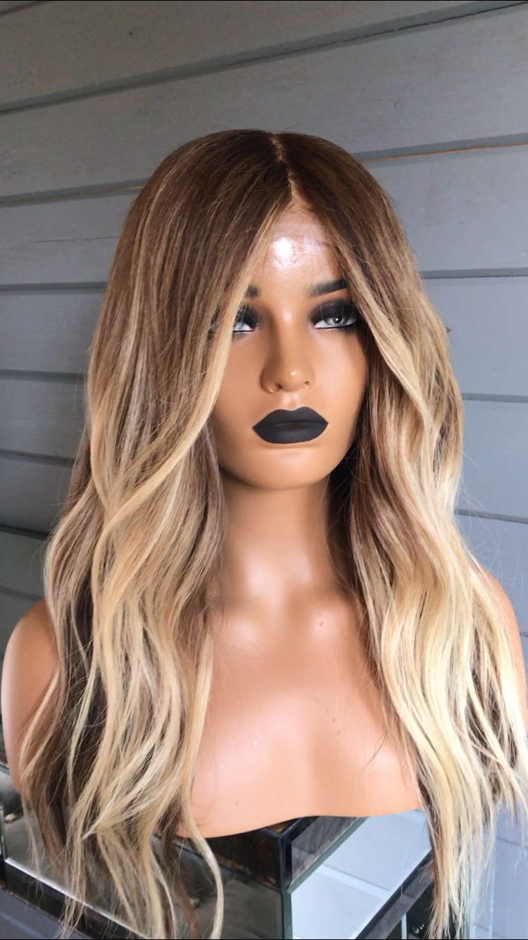  Long, wavy golden brown to balayage blonde hair, wearing a lace frontal wig cap.- Nuola Wigs