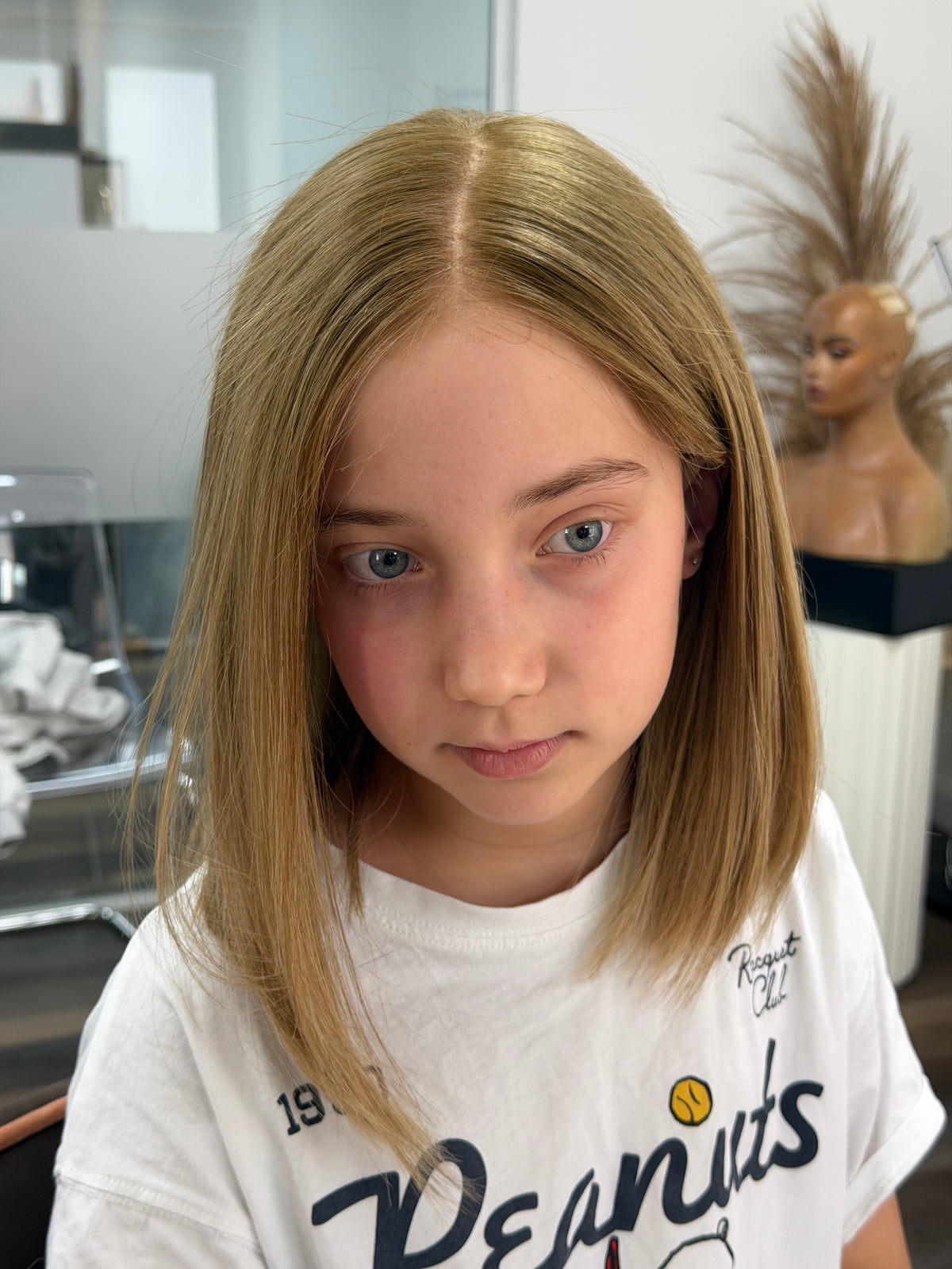 Child wearing the Daisy blonde human hair wig with a natural hairline