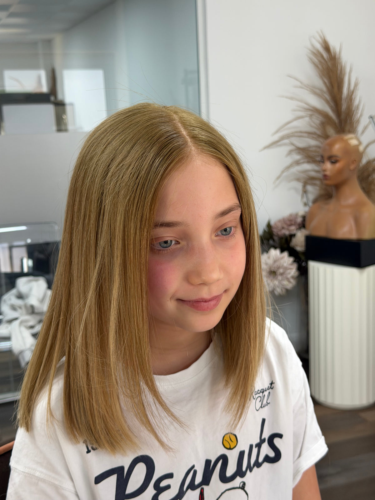 Child wearing the Daisy blonde human hair wig with a natural hairline