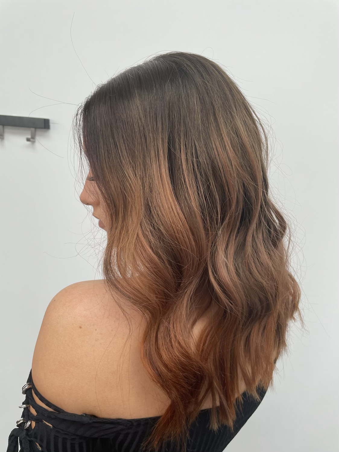 Model wearing auburn 16-inch HD lace human hair wig in body wave texture – Nuola Wigs.