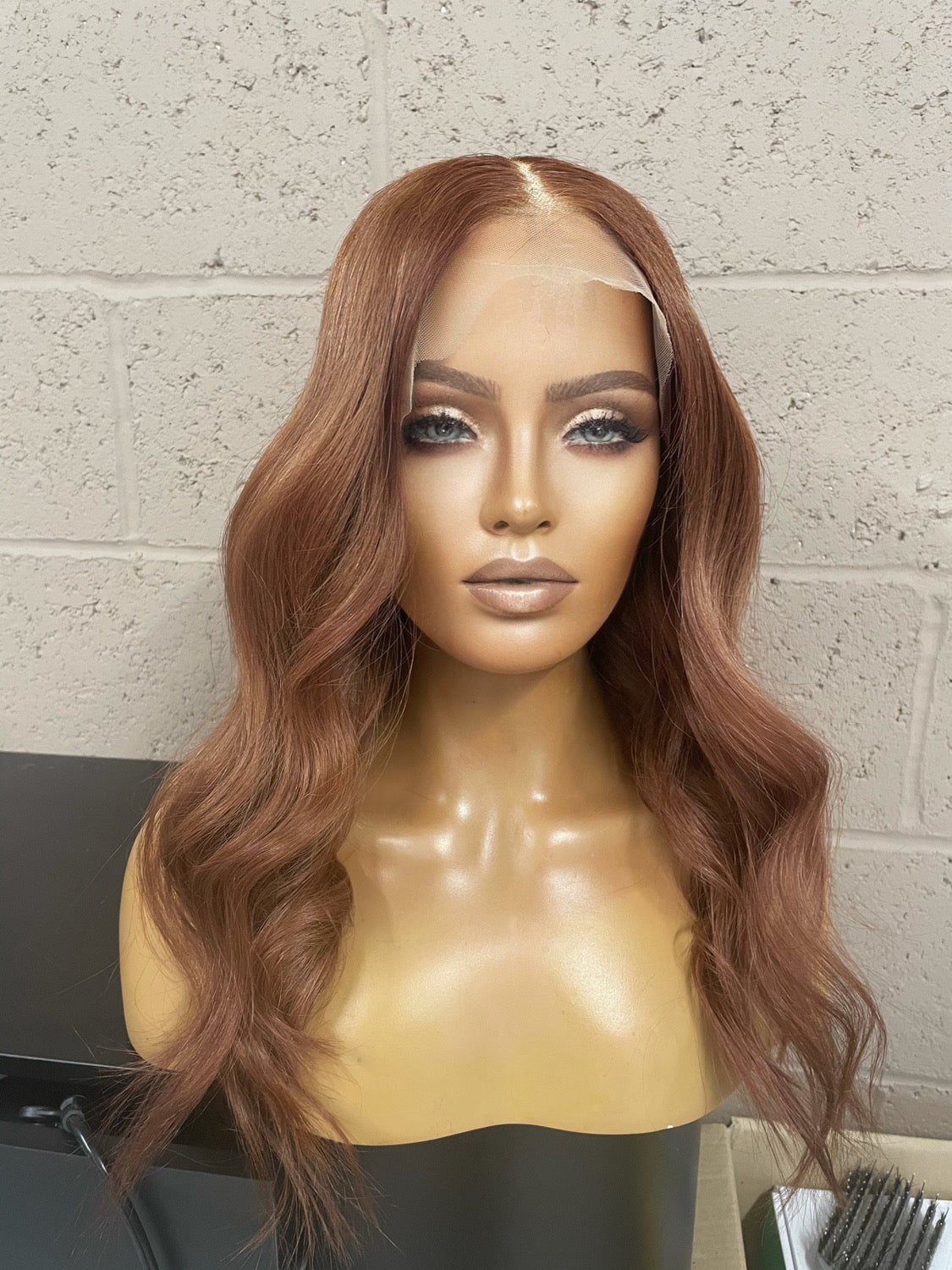 Model wearing auburn 18-inch HD lace human hair wig in body wave texture – Nuola Wigs.