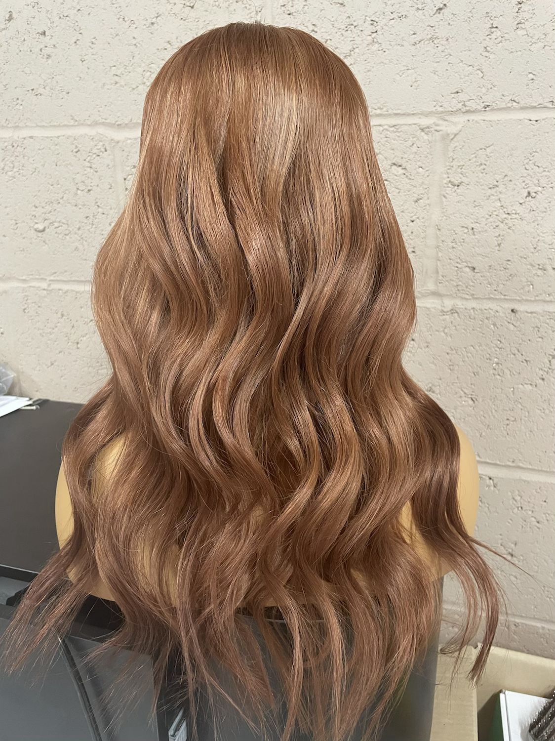 Model wearing auburn 18-inch HD lace human hair wig in body wave texture – Nuola Wigs.