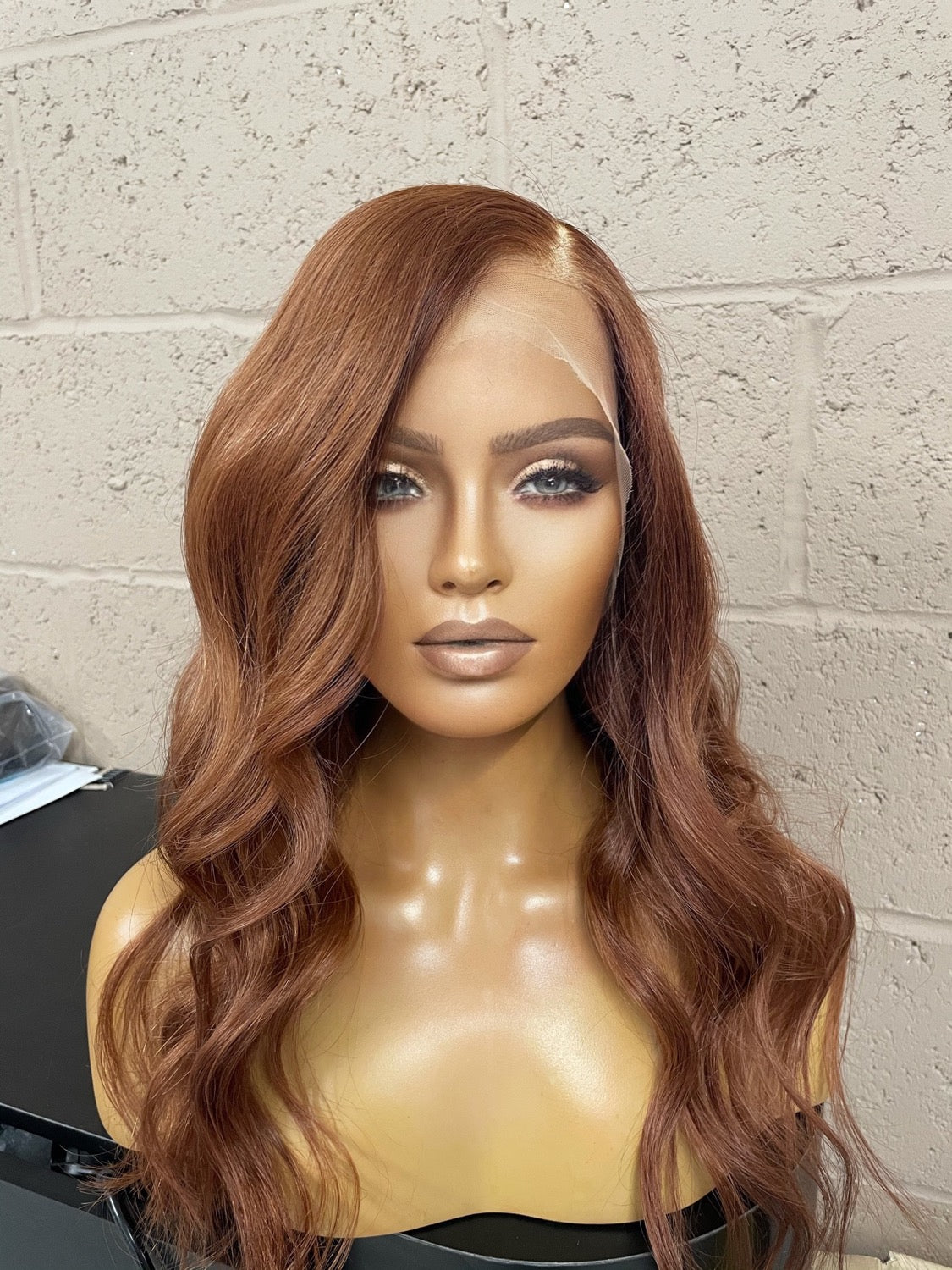Model wearing auburn 18-inch HD lace human hair wig in body wave texture – Nuola Wigs.