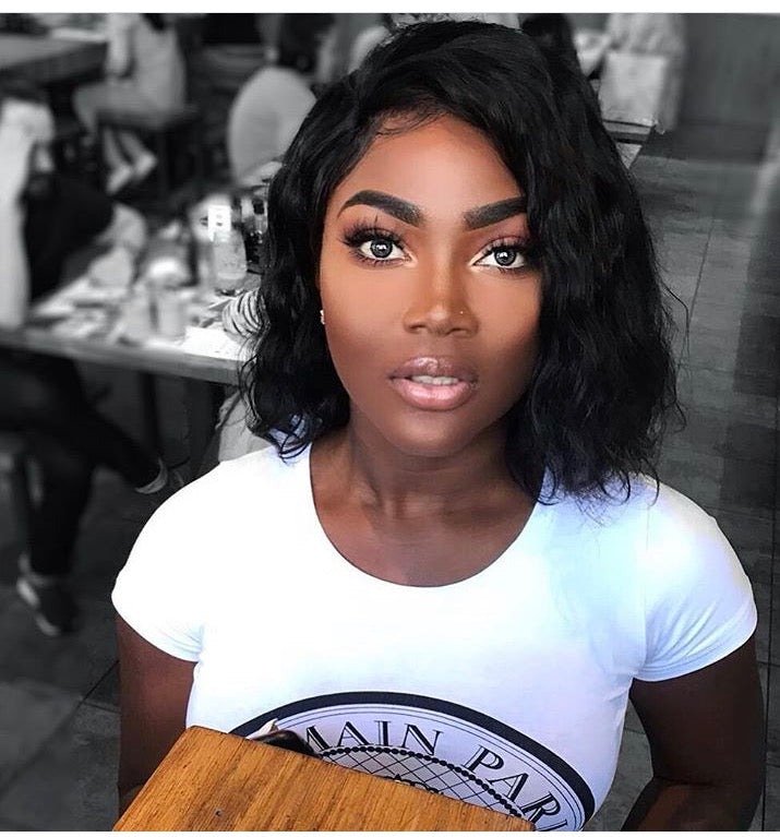 Model wearing black 10-inch HD lace human hair wig in body wave texture – Nuola Wigs.