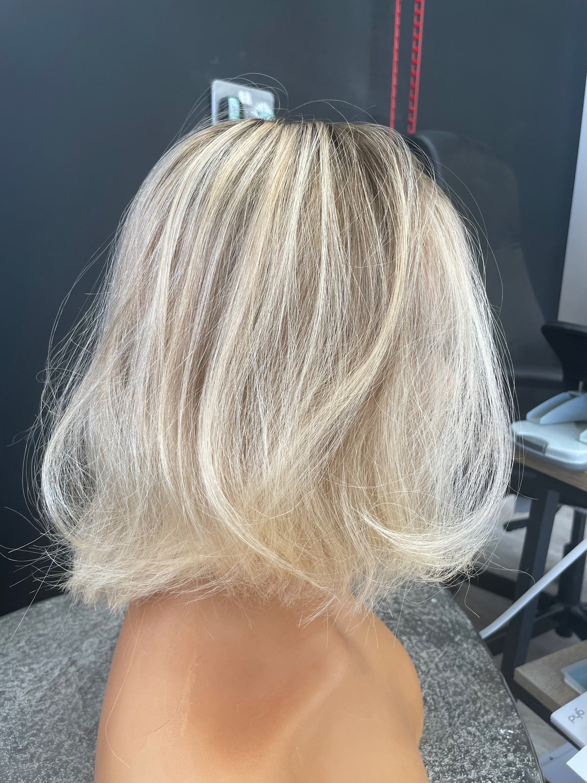 Model wearing blonde balayage 12-inch HD lace human hair wig in body wave texture – Nuola Wigs.