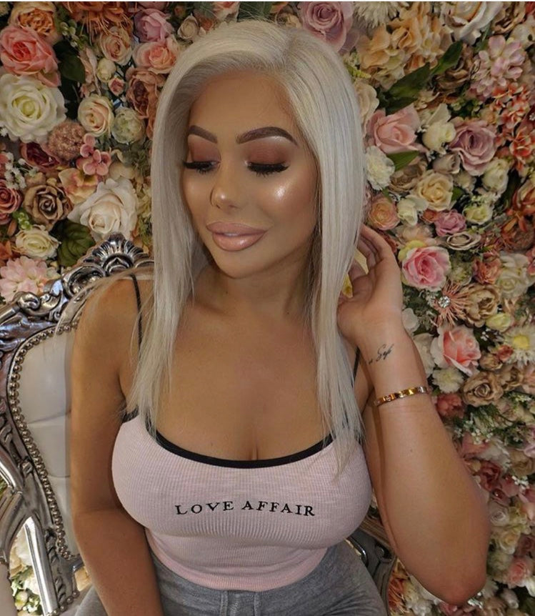 Model wearing blonde balayage 14-inch HD lace human hair wig in body wave texture – Nuola Wigs.