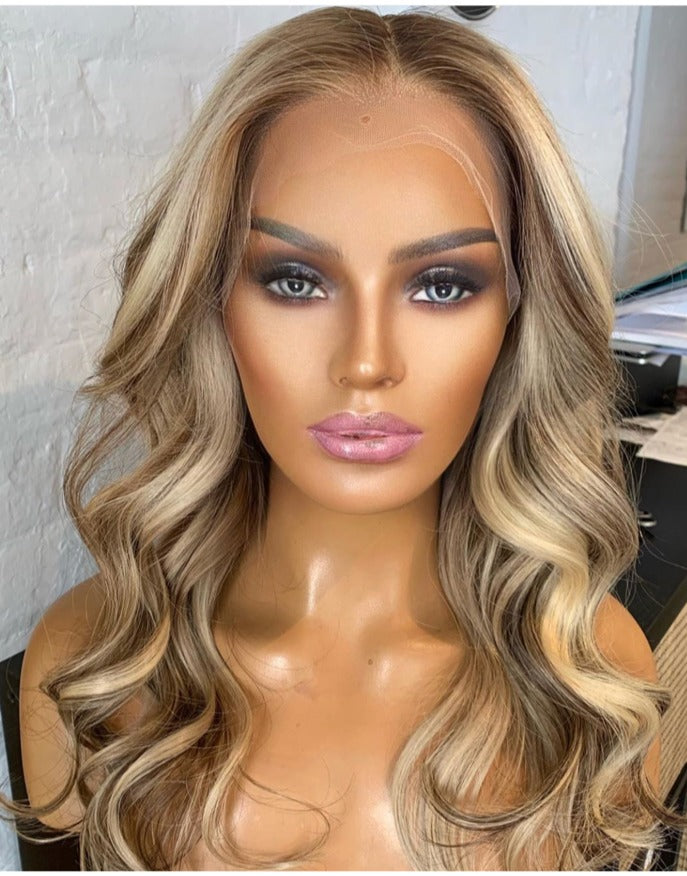 Model wearing blonde balayage 16-inch HD lace human hair wig in body wave texture – Nuola Wigs.