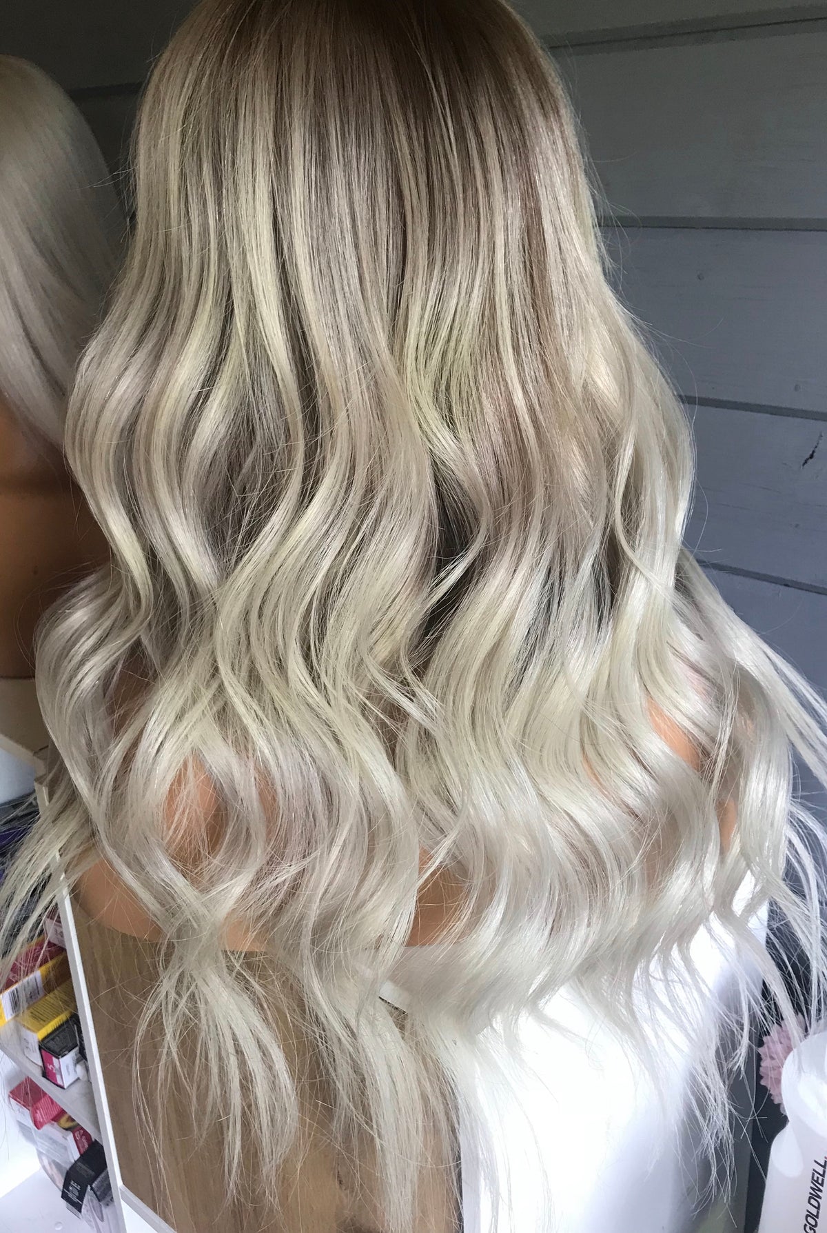 Model wearing blonde balayage 17-inch HD lace human hair wig in body wave texture – Nuola Wigs.