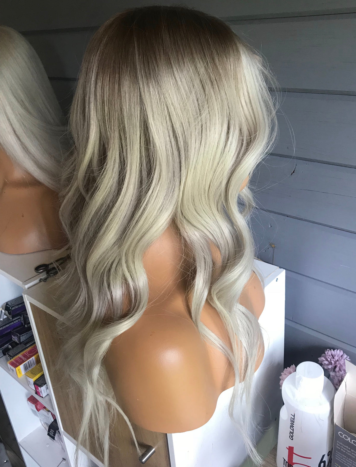 Model wearing blonde balayage 17-inch HD lace human hair wig in body wave texture – Nuola Wigs.