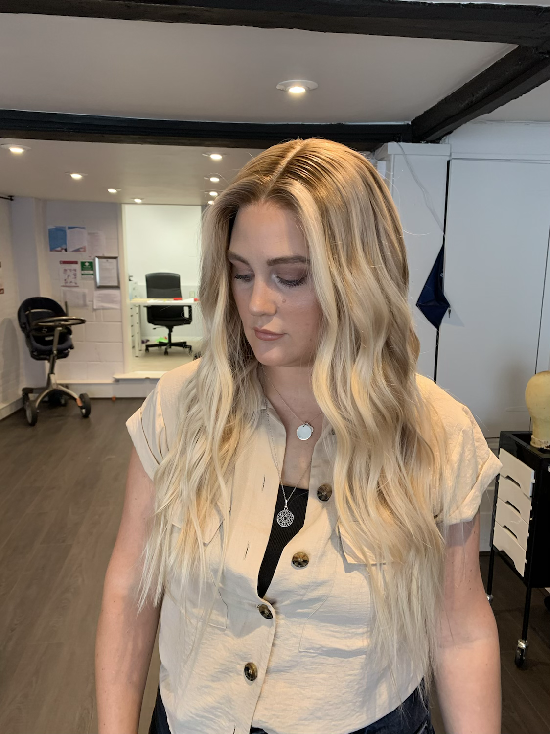 Model wearing blonde balayage 20-inch HD lace human hair wig in body wave texture – Nuola Wigs.