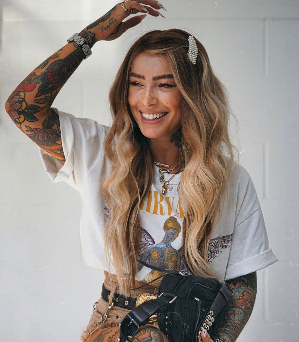 Model wearing blonde balayage 20-inch HD lace human hair wig in body wave texture – Nuola Wigs.