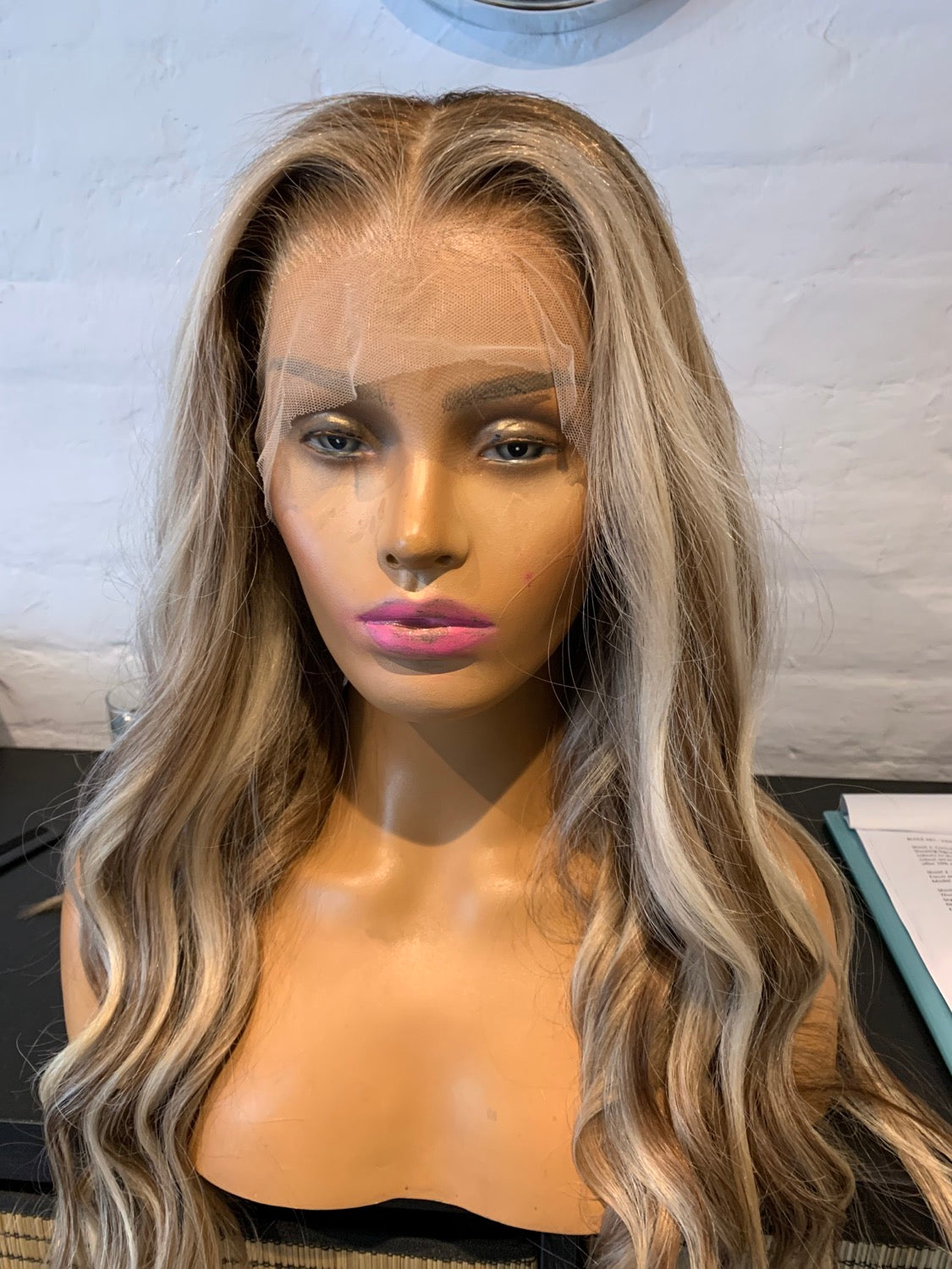 Model wearing blonde balayage 22-inch HD lace human hair wig in body wave texture – Nuola Wigs.