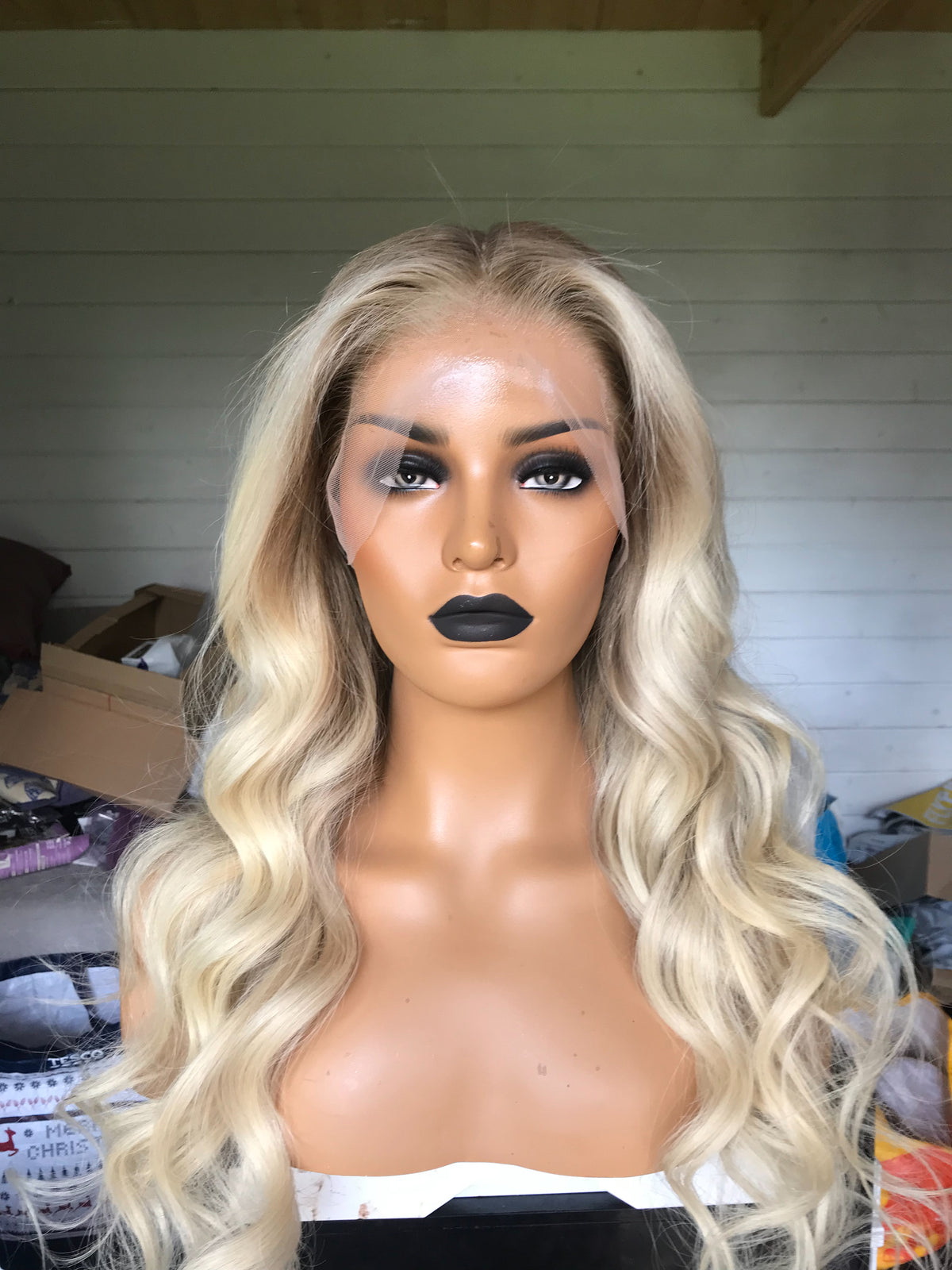Model wearing blonde balayage 22-inch HD lace human hair wig in body wave texture – Nuola Wigs.
