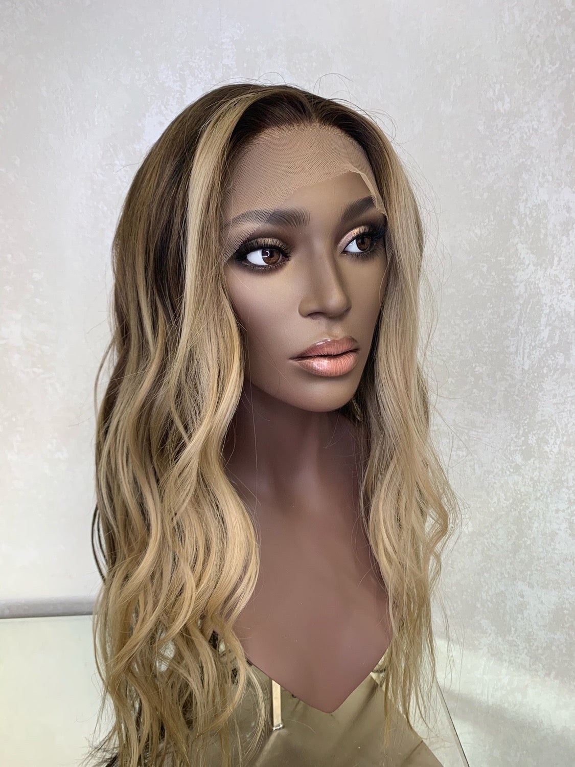 Model wearing blonde balayage 22-inch HD lace human hair wig in body wave texture – Nuola Wigs.