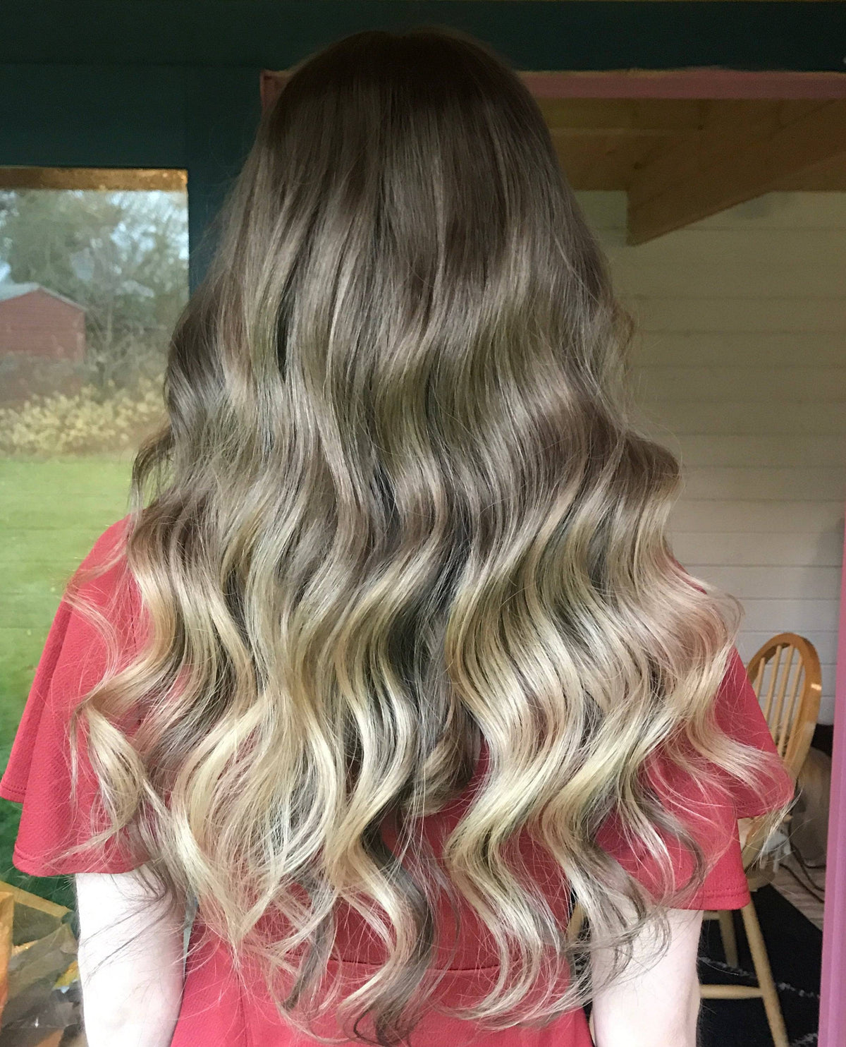 Model wearing blonde balayage 22-inch HD lace human hair wig in body wave texture – Nuola Wigs.