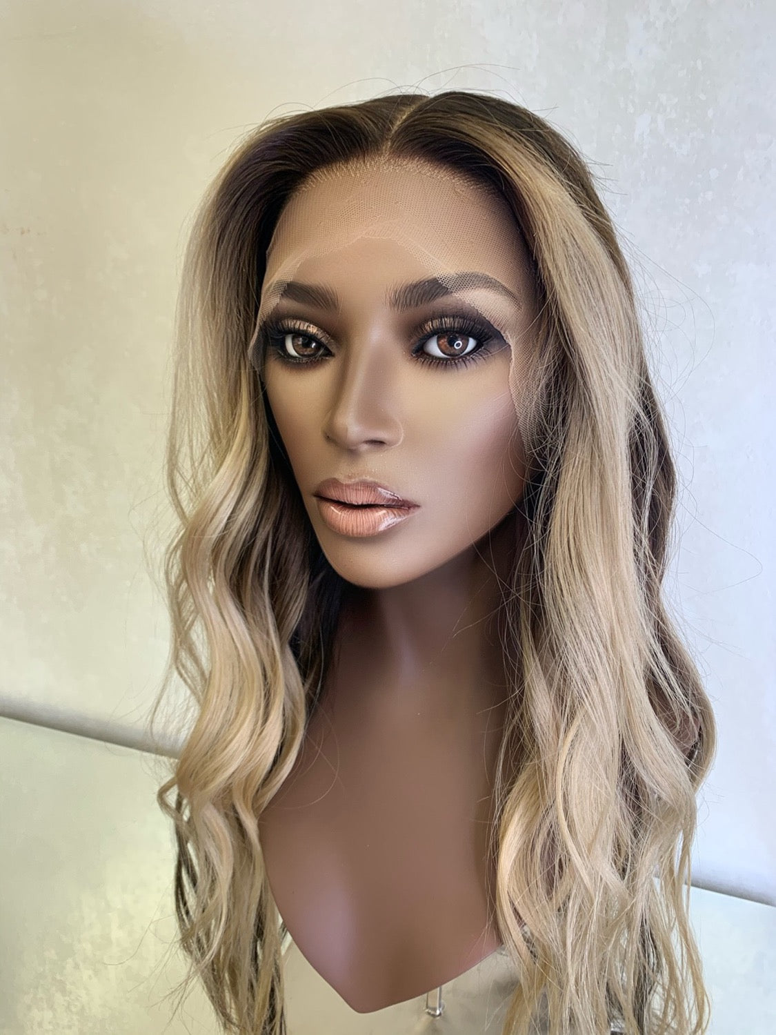 Model wearing blonde balayage 22-inch HD lace human hair wig in body wave texture – Nuola Wigs.