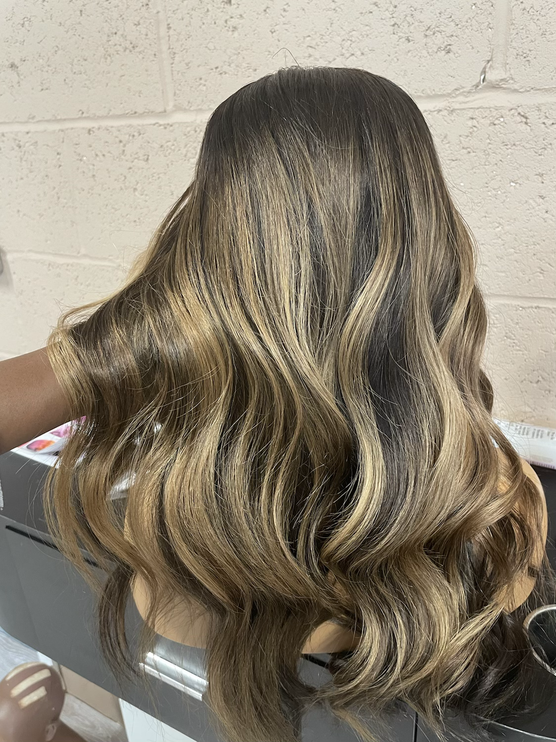 Model wearing brown balayage 20-inch HD lace human hair wig in body wave texture – Nuola Wigs.