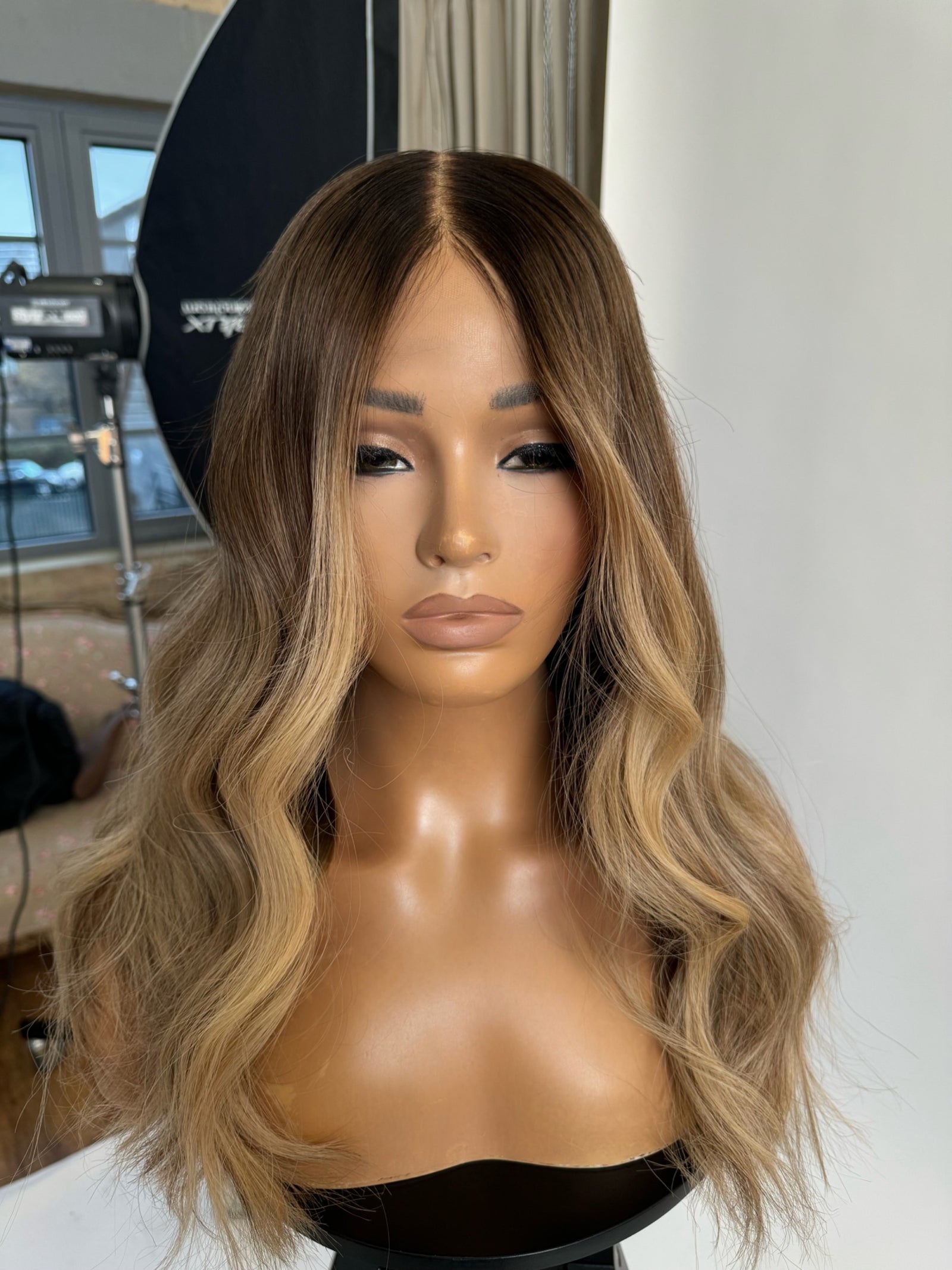 Model wearing brown balayage 20-inch HD lace human hair wig in body wave
texture – Nuola Wigs.