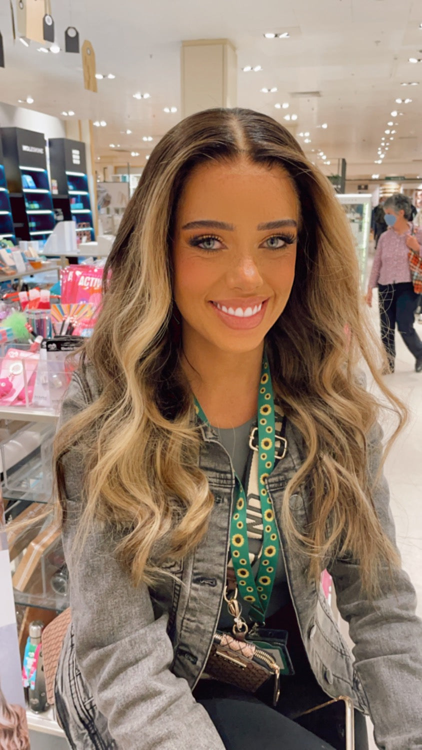 Model wearing brown balayage 22-inch HD lace human hair wig in body wave texture – Nuola Wigs.