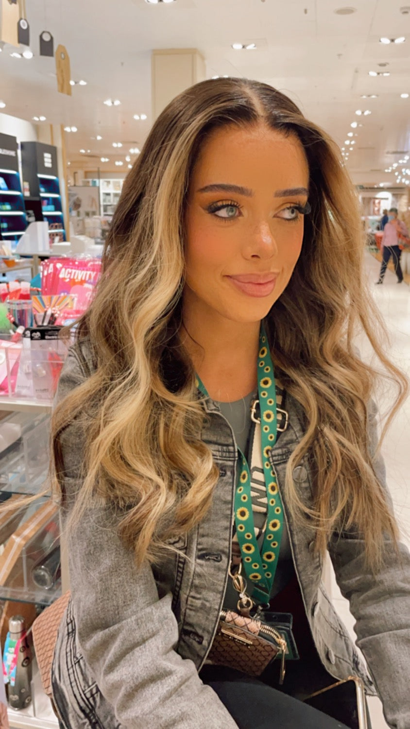 Model wearing brown balayage 22-inch HD lace human hair wig in body wave texture – Nuola Wigs.