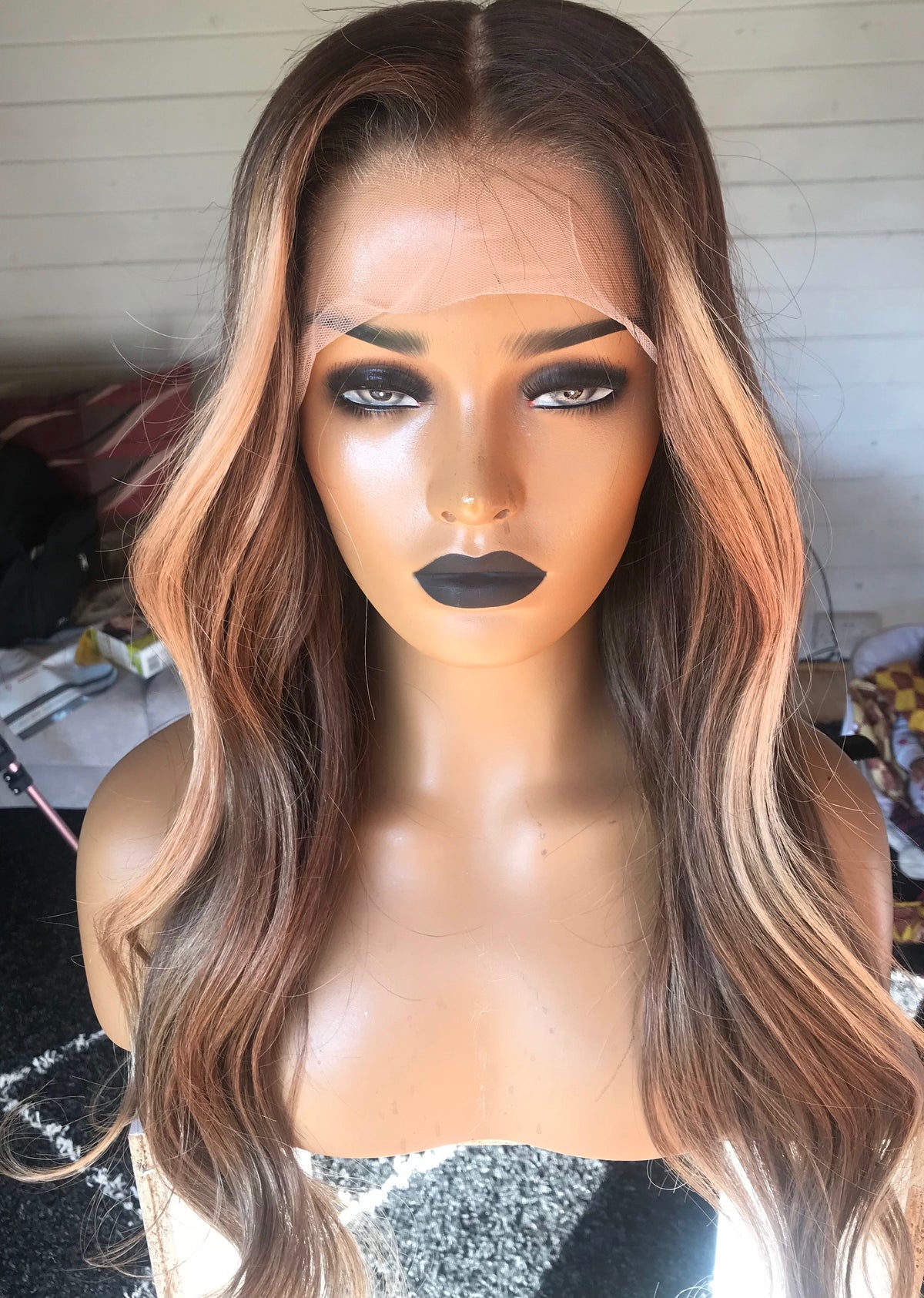 Model wearing brown balayage 22-inch HD lace human hair wig in body wave
texture – Nuola Wigs.