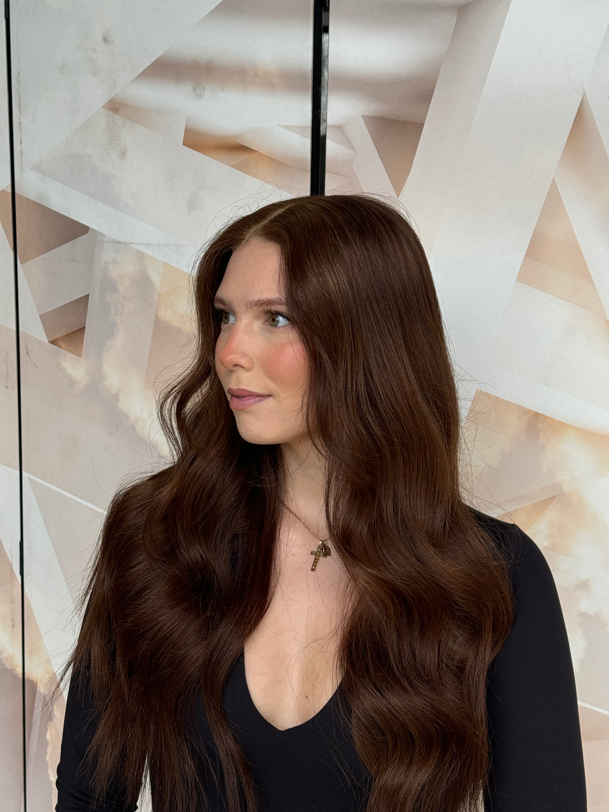 Model wearing brown balayage 24-inch HD lace human hair wig in body wave
texture – Nuola Wigs.