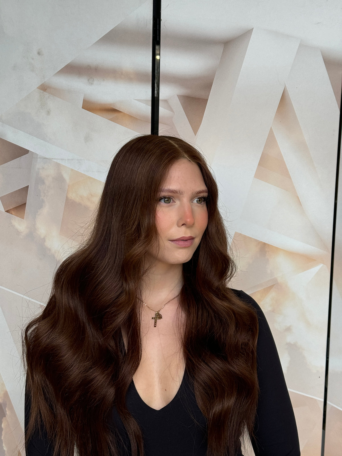 Model wearing brown balayage 24-inch HD lace human hair wig in body wave
texture – Nuola Wigs.