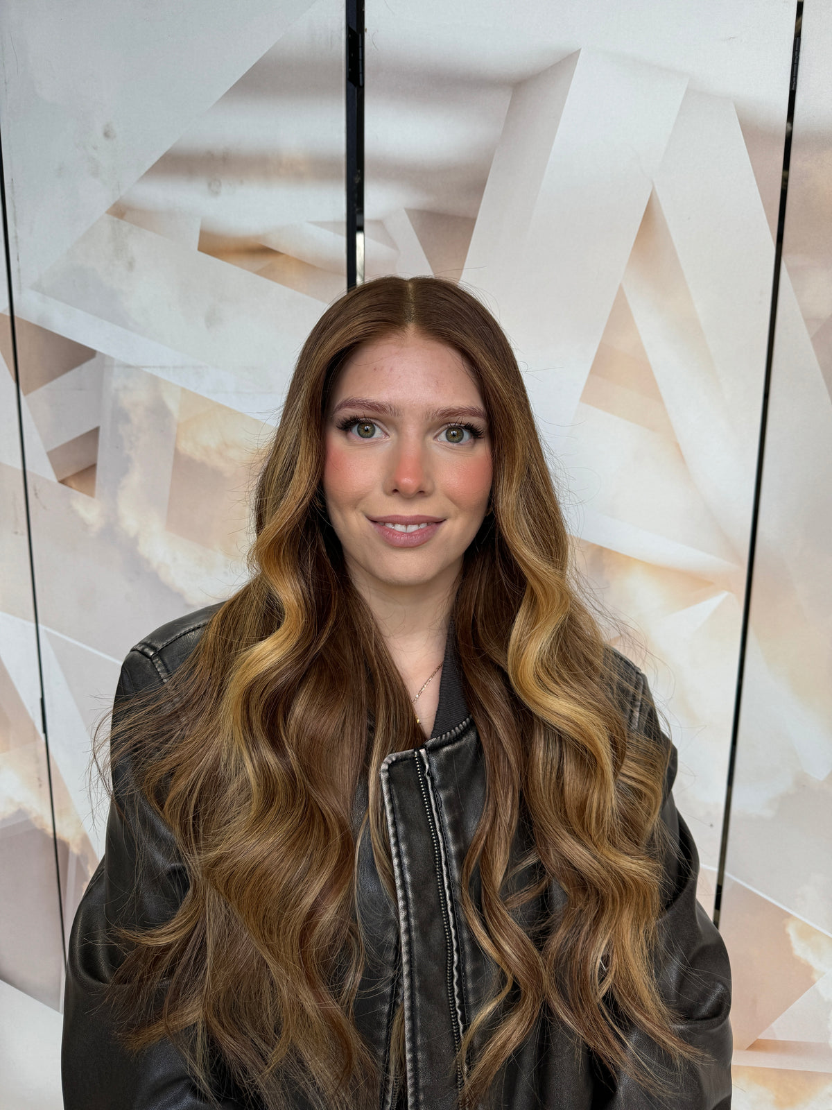 Model wearing brown balayage 24-inch HD lace human hair wig in body wave
texture – Nuola Wigs.