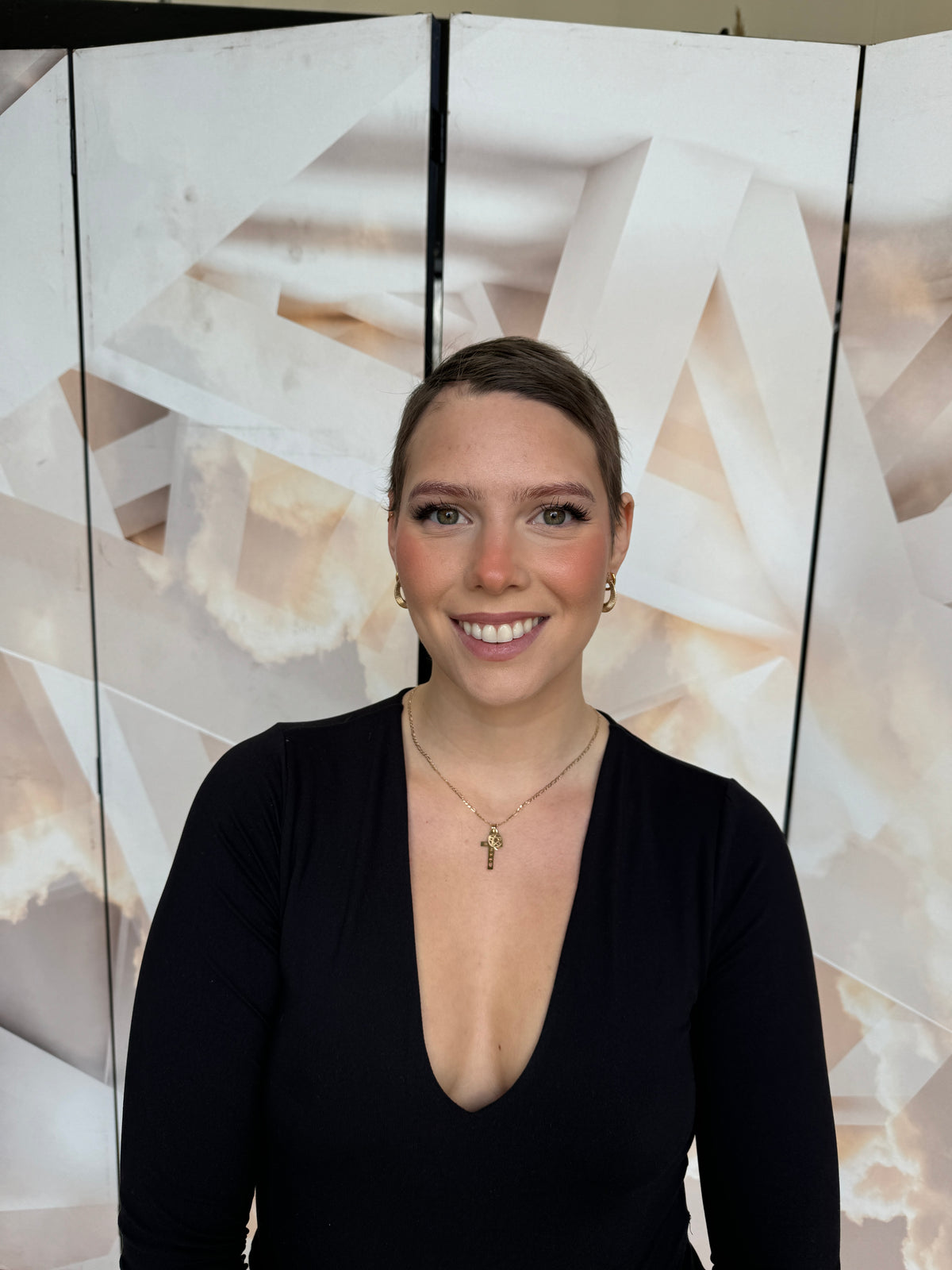 Model wearing brown balayage 24-inch HD lace human hair wig in body wave
texture – Nuola Wigs.