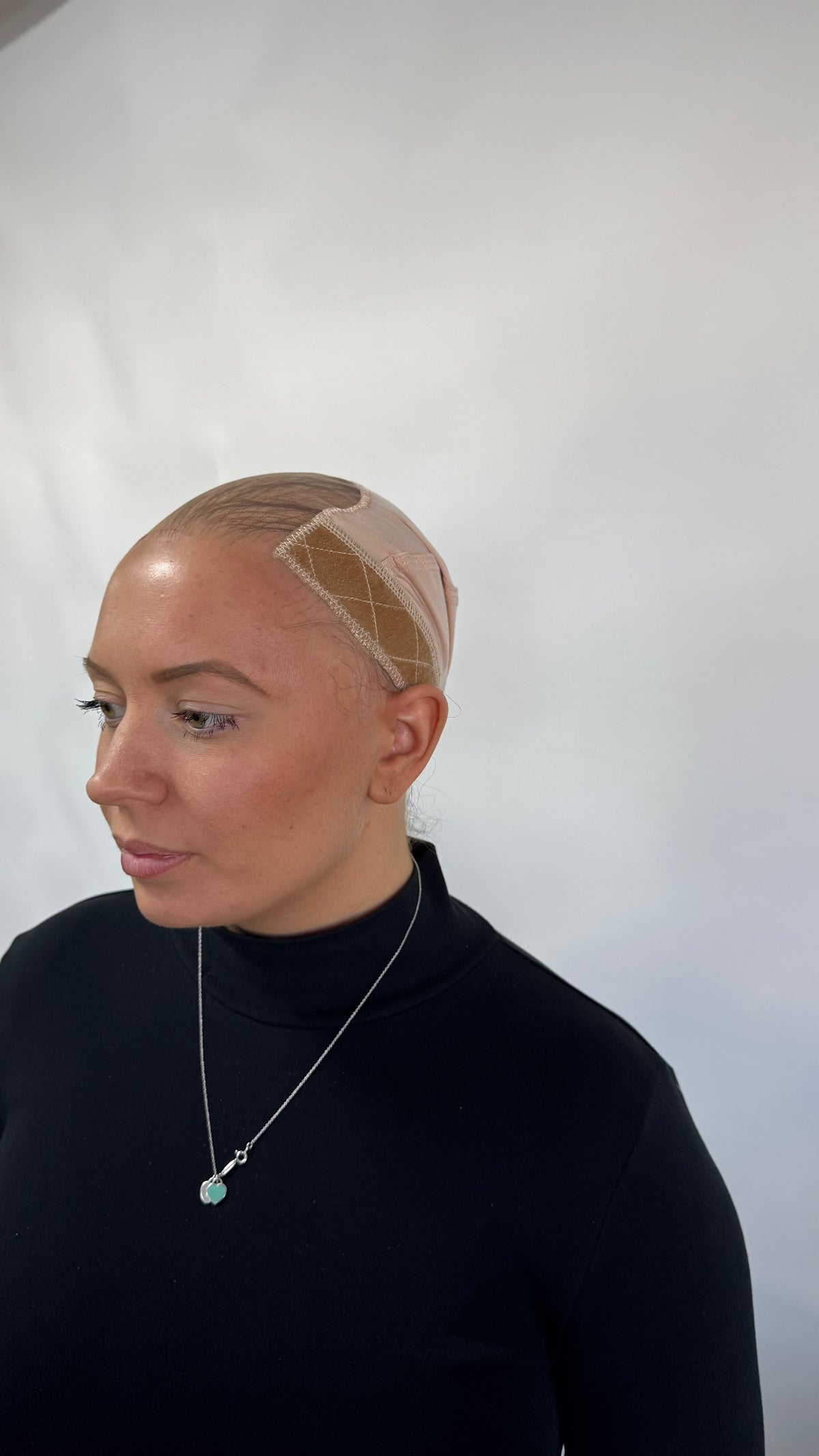 Model wearing blonde balayage 22-inch HD lace human hair wig in body wave
texture – Nuola Wigs.