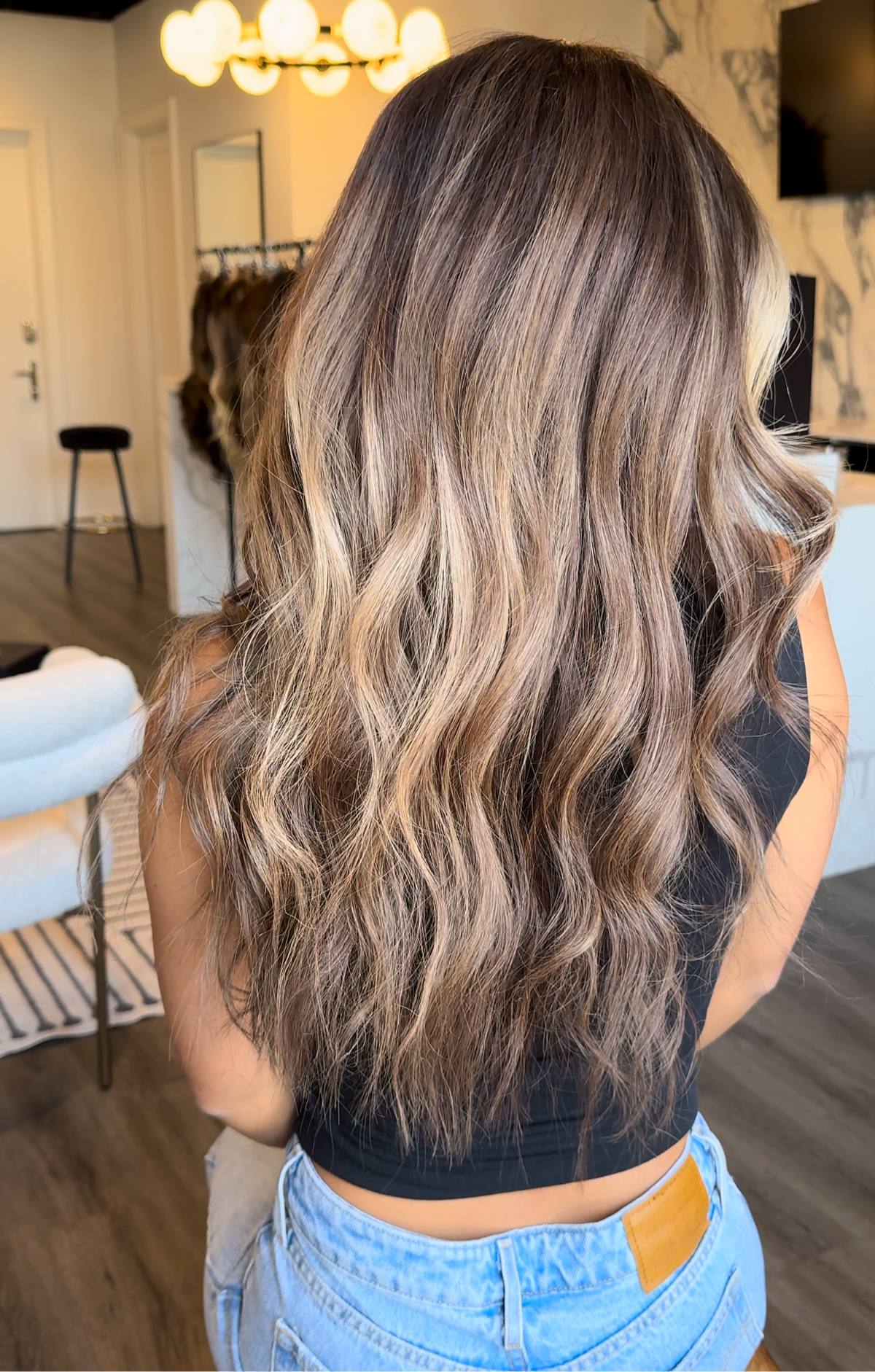 Model wearing brown balayage 20-inch HD lace human hair wig in body wave
texture – Nuola Wigs.