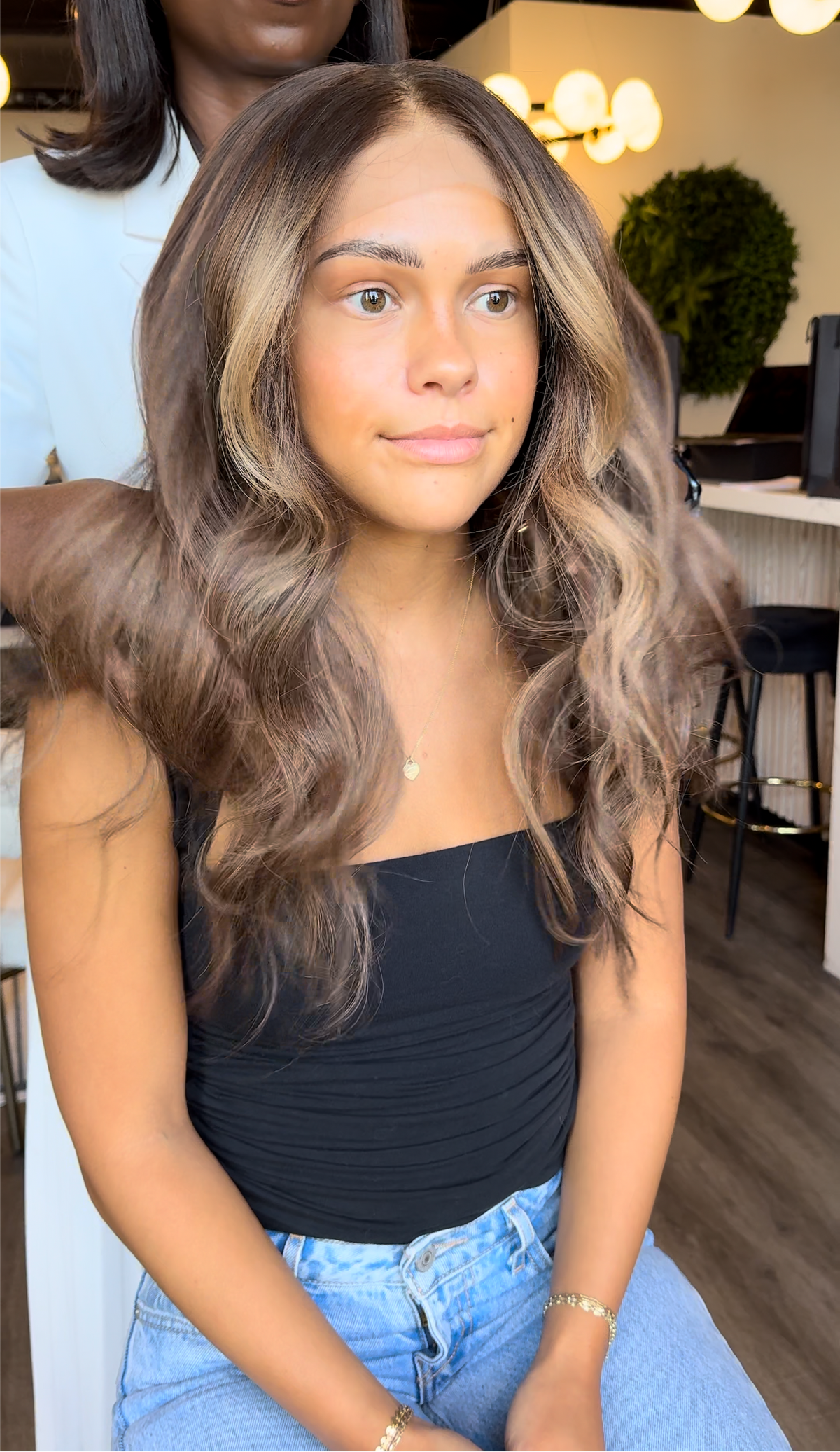 Model wearing brown balayage 20-inch HD lace human hair wig in body wave
texture – Nuola Wigs.