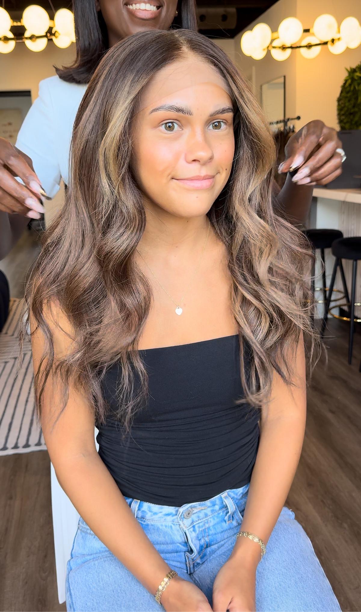 Model wearing brown balayage 20-inch HD lace human hair wig in body wave
texture – Nuola Wigs.