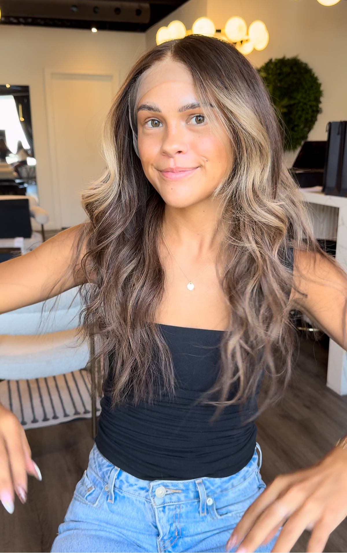 Model wearing brown balayage 20-inch HD lace human hair wig in body wave
texture – Nuola Wigs.