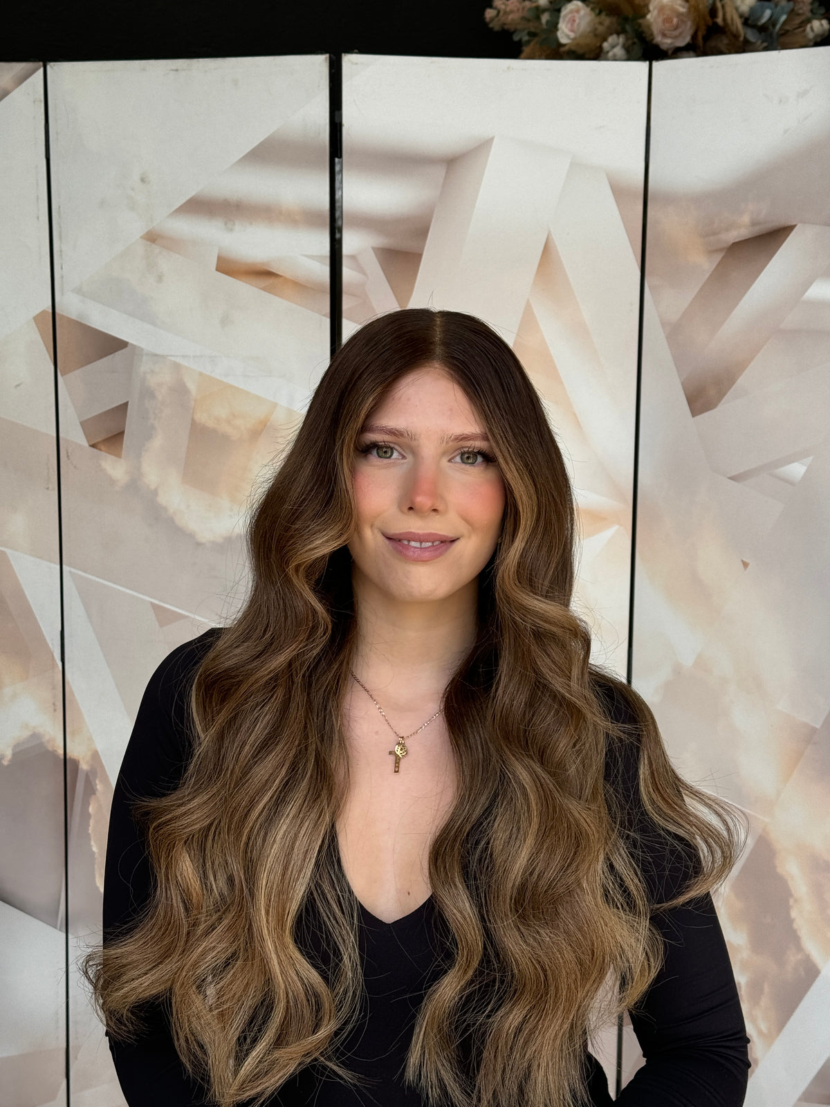 Model wearing brown balayage 24-inch HD lace human hair wig in body wave
texture – Nuola Wigs.